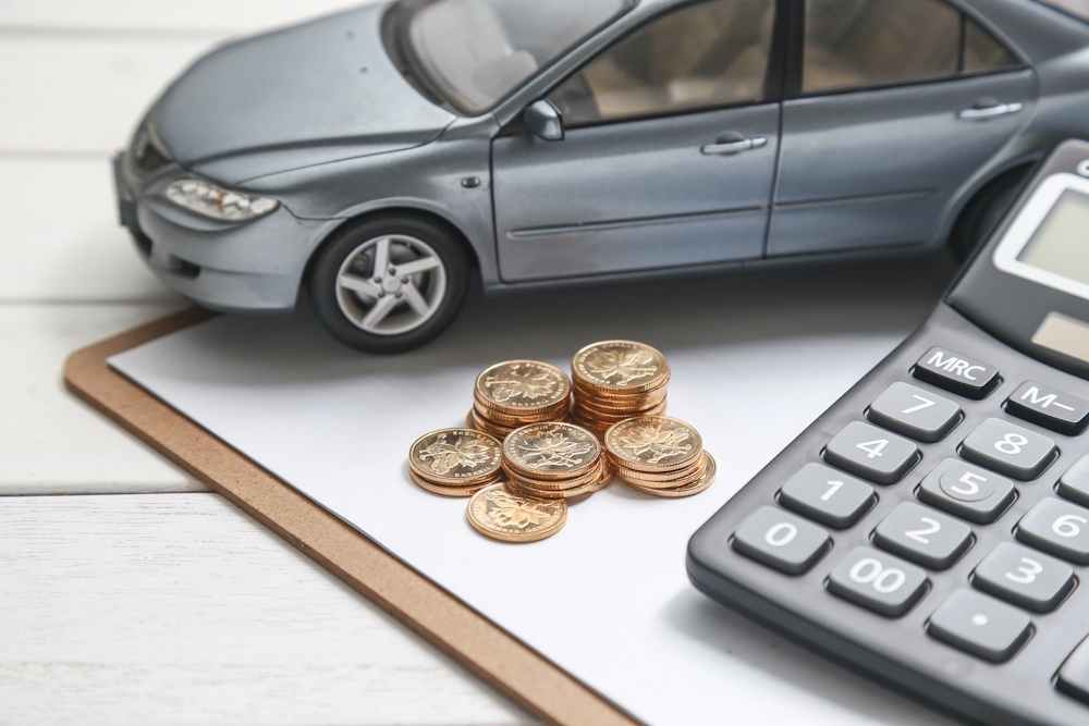 Car, calculator and euro coins representing an import tax estimate